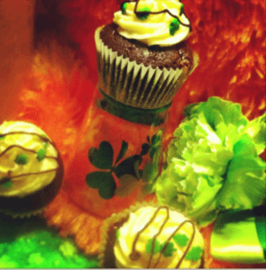 St. Patrick's Day-themed cupcakes with green decorations and a festive background.