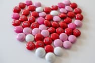 A heart made of red, pink, and white M&M candies.