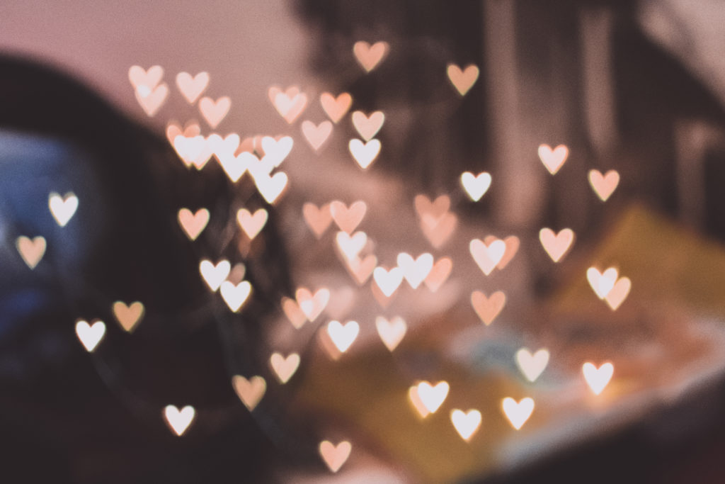 Pastel hearts over a blurry background.