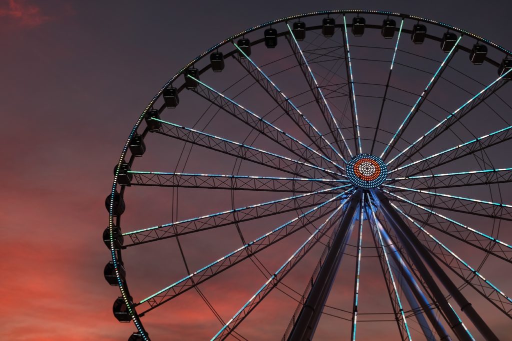 Large ferris wheel lit up at dusk