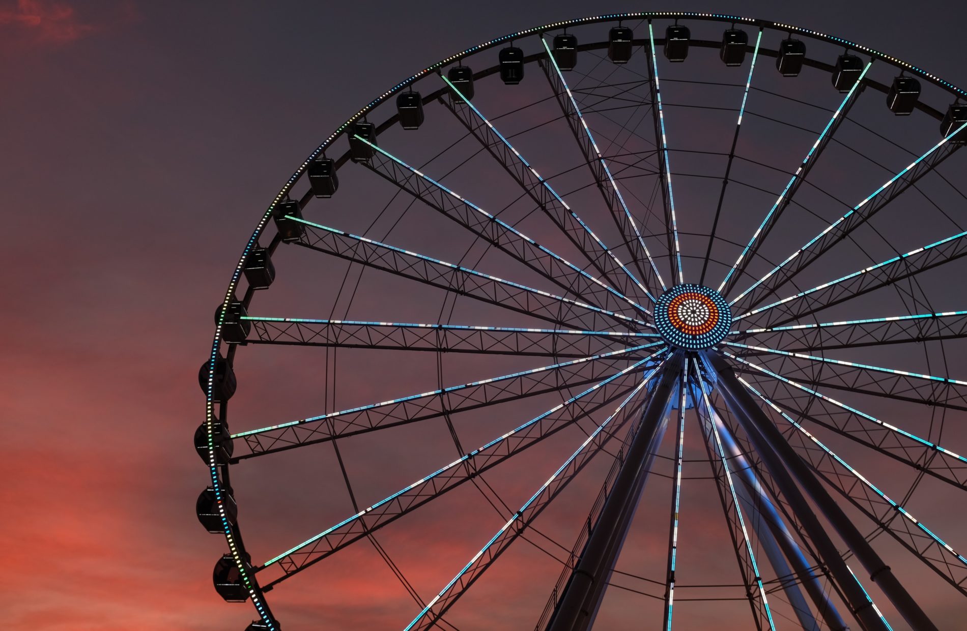 Large ferris wheel lit up at dusk