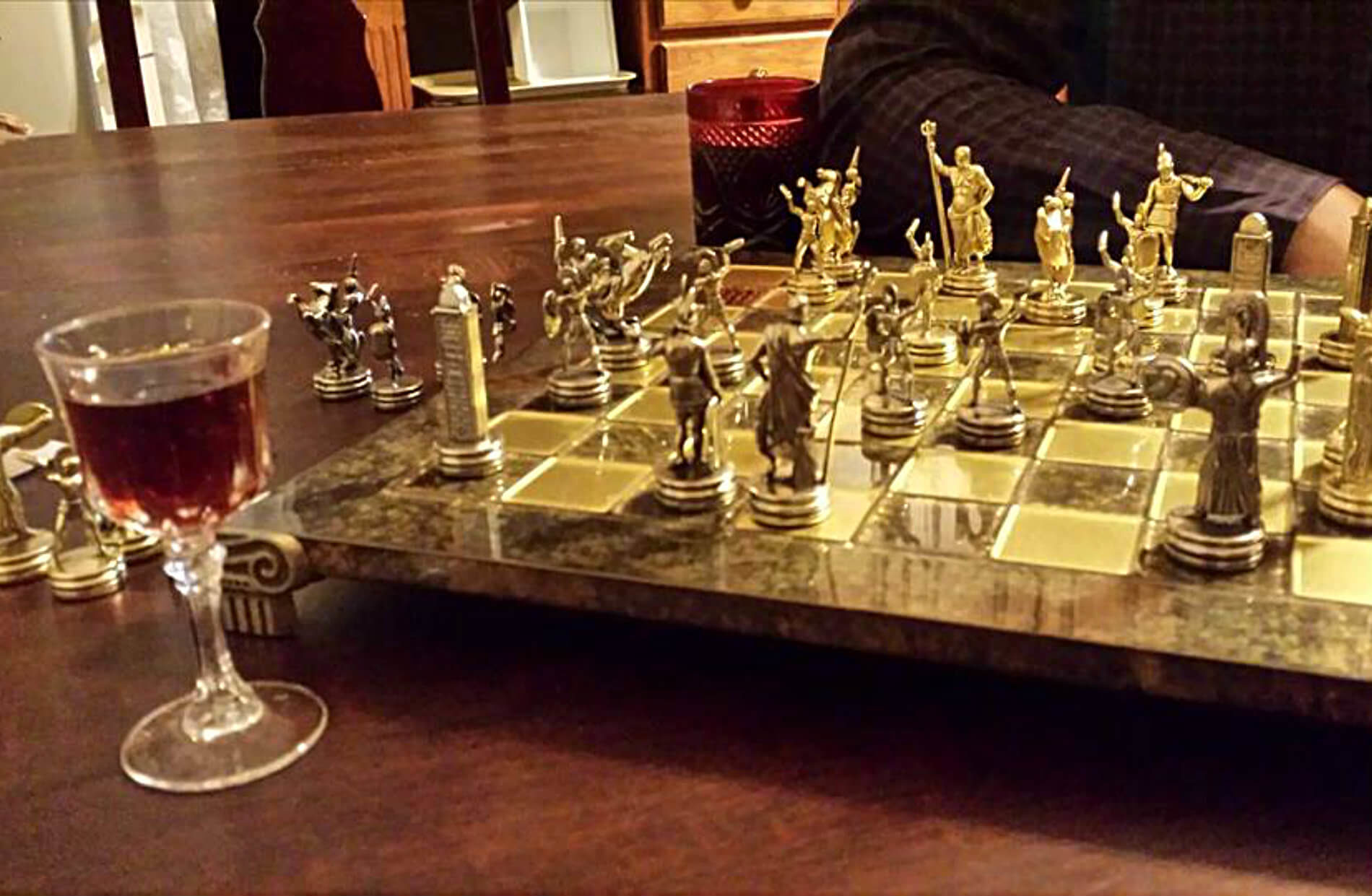 Beautiful chess board set with silver chess pieces on glossy wood table