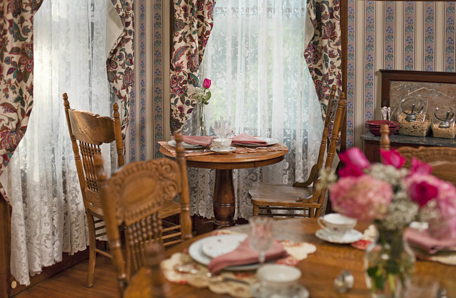 Wooden tables with plates and tea cups with a floral pattern