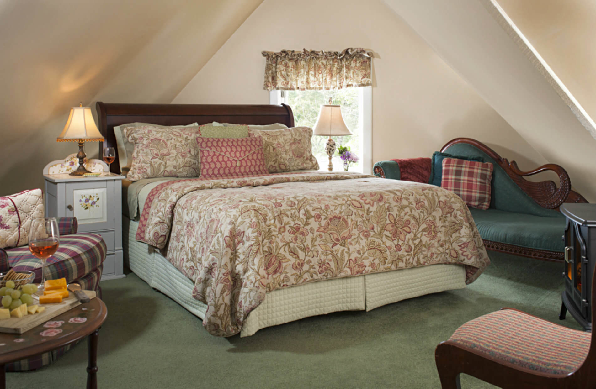 Wooden bed in gabled room with green carpet