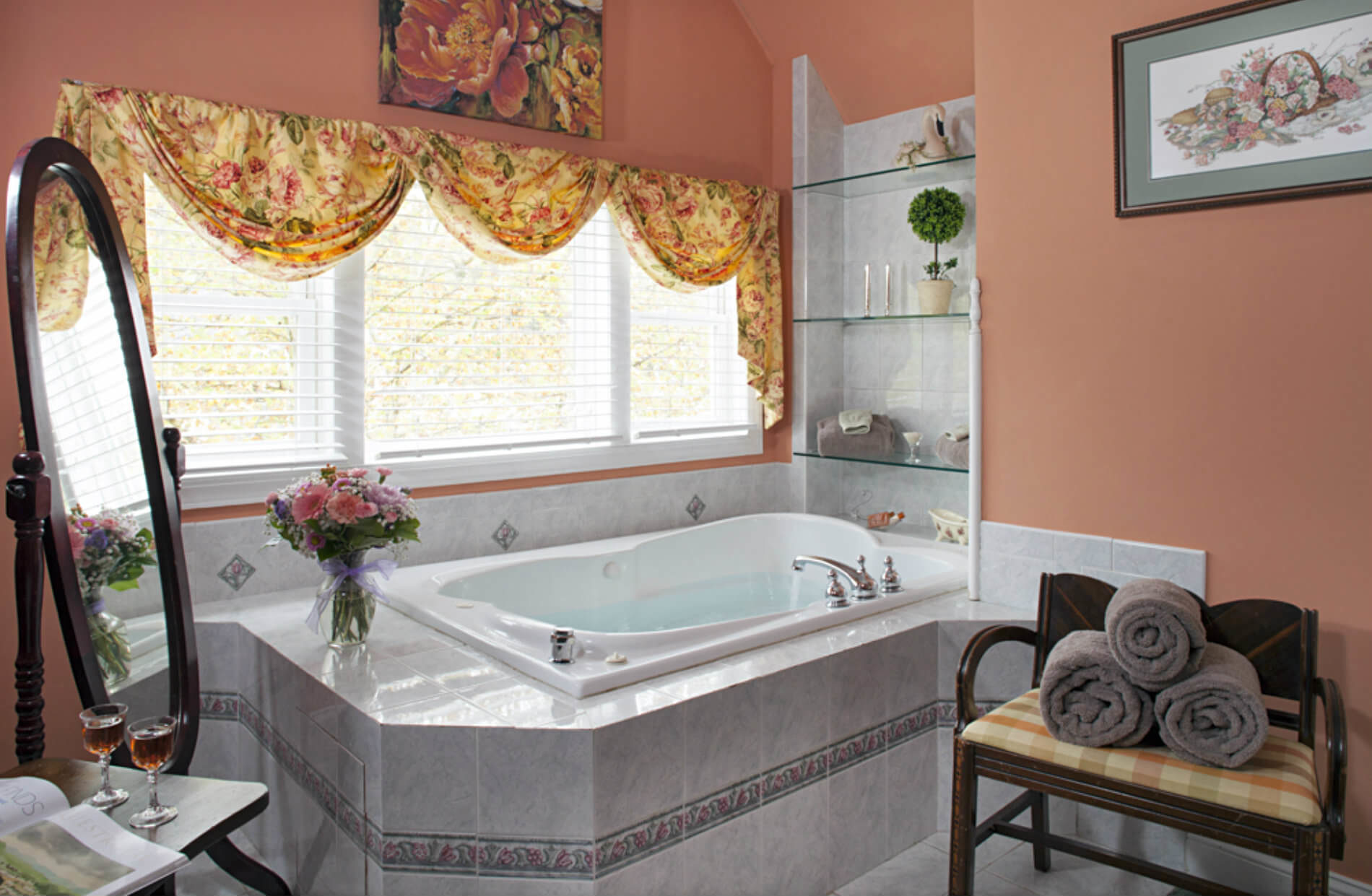 Deep step-in tub in room with peach walls with large window over it
