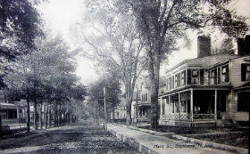 Black and white photo of the main street with a large building in the foreground
