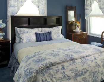 queen bed with French blue toile bedding and curtains