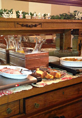 Wooden buffet laden with breakfast dishes