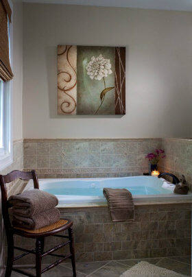 Serene bath with tile backsplash and large flower picture