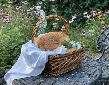 sourdough loaf of bread in a picnic basket