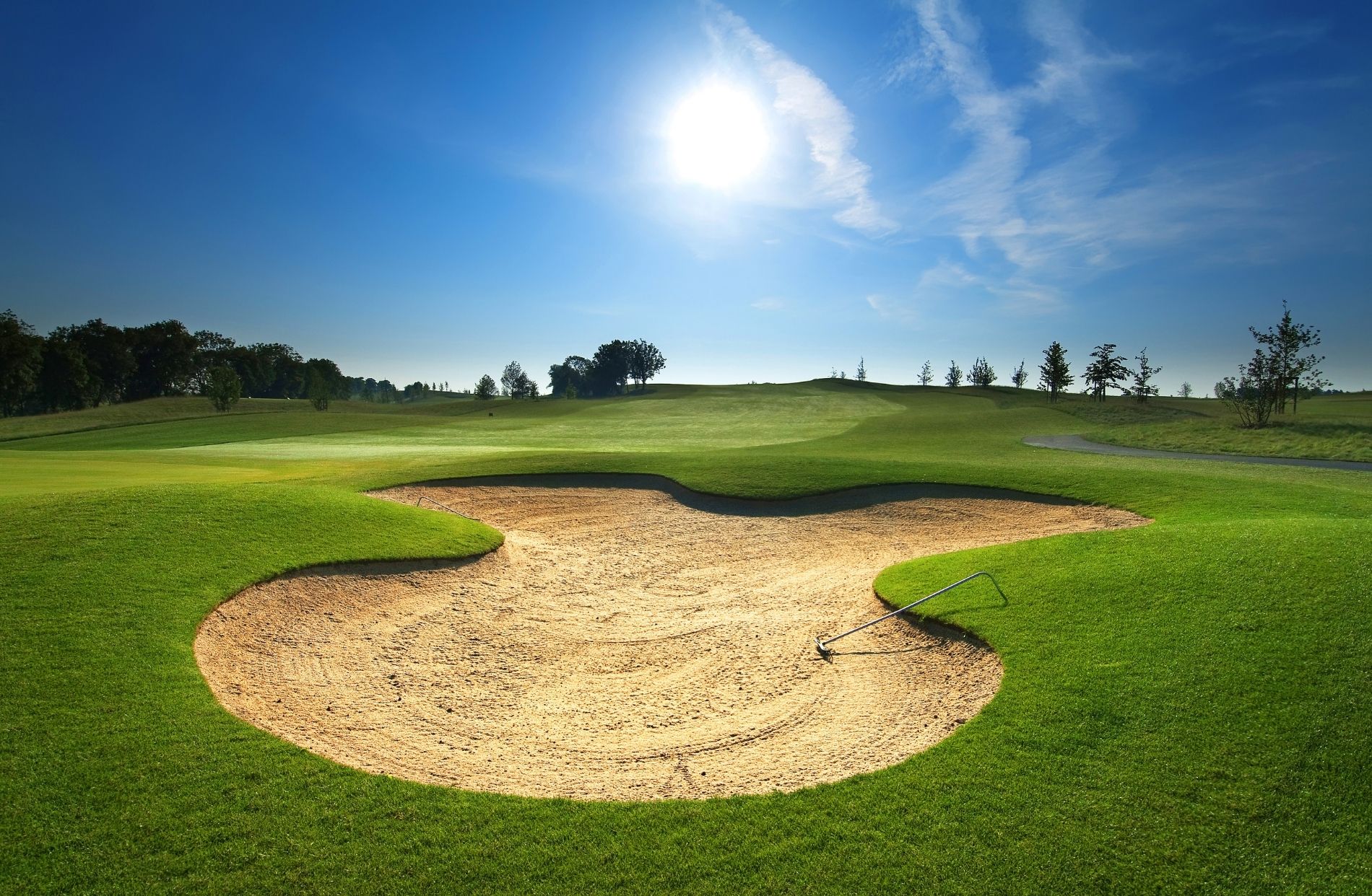 View of golf course, sand trap and blue skies